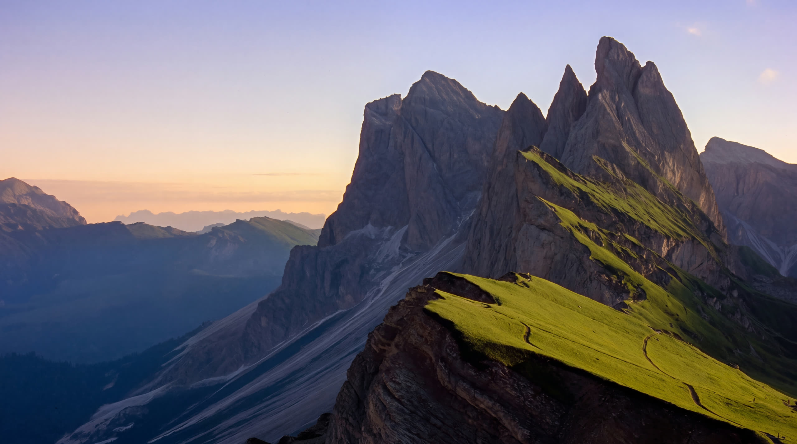 The Seceda ridgeline in the Dolomites at golden hour, its green meadow lit by the low sun